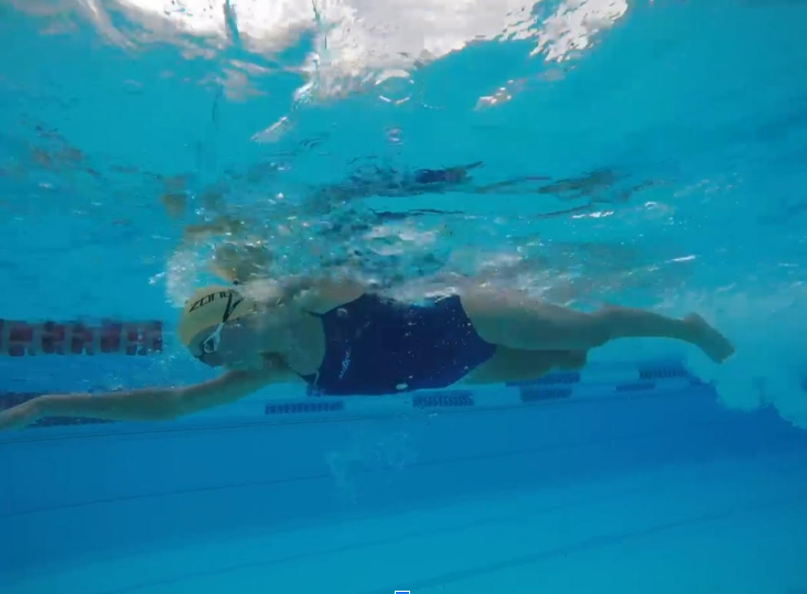 Underwater photo of the same swimmer in a swimming pool doing front crawl